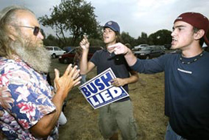 (Paul T. Erickson) Anti-Bush protestors Dan Teimouri, 18, right, and Dash Miller, 19, both of Kennewick exchange heated words with Dewayne Harvill of Burbank who supports Bush. The confrontaion happened in the parking lot of Hood River Park.