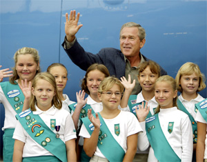 (AP: J. Scott Applewhite) President Bush is welcomed by local girl scouts as he arrives in Pasco, Wash. where he visited the Ice Harbor Dam on the Snake River in Burbank, Wash., to promote his agenda on salmon restoration.