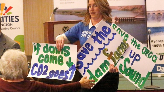 Stephanie Barnard hands out signs at a rally in support of the lower Snake River dams in 2020. Barnard is campaigning for the Washington state Legislature to represent District 8. (Bob Brawdy photo)