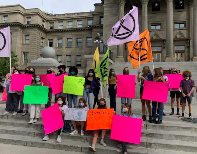 The Boise High Green Club, while wearing CoVid-19 masks, gather in protest on the Idaho State Capitol steps.