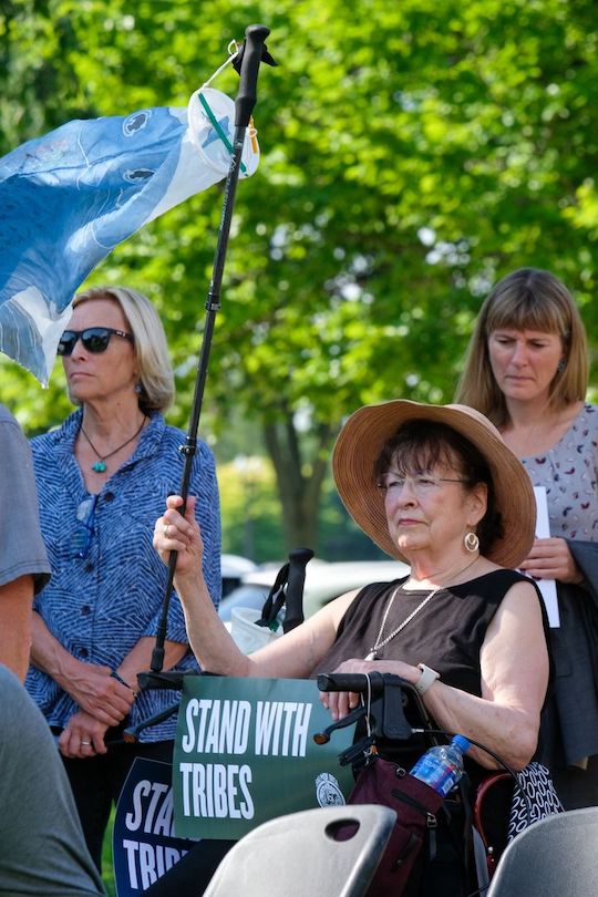 An audience member holds a sign at a rally outside the U.S. Capitol on July 14, 2022, organized by Northwest tribes in support of breaching the Lower Snake River dams to help restore salmon runs.