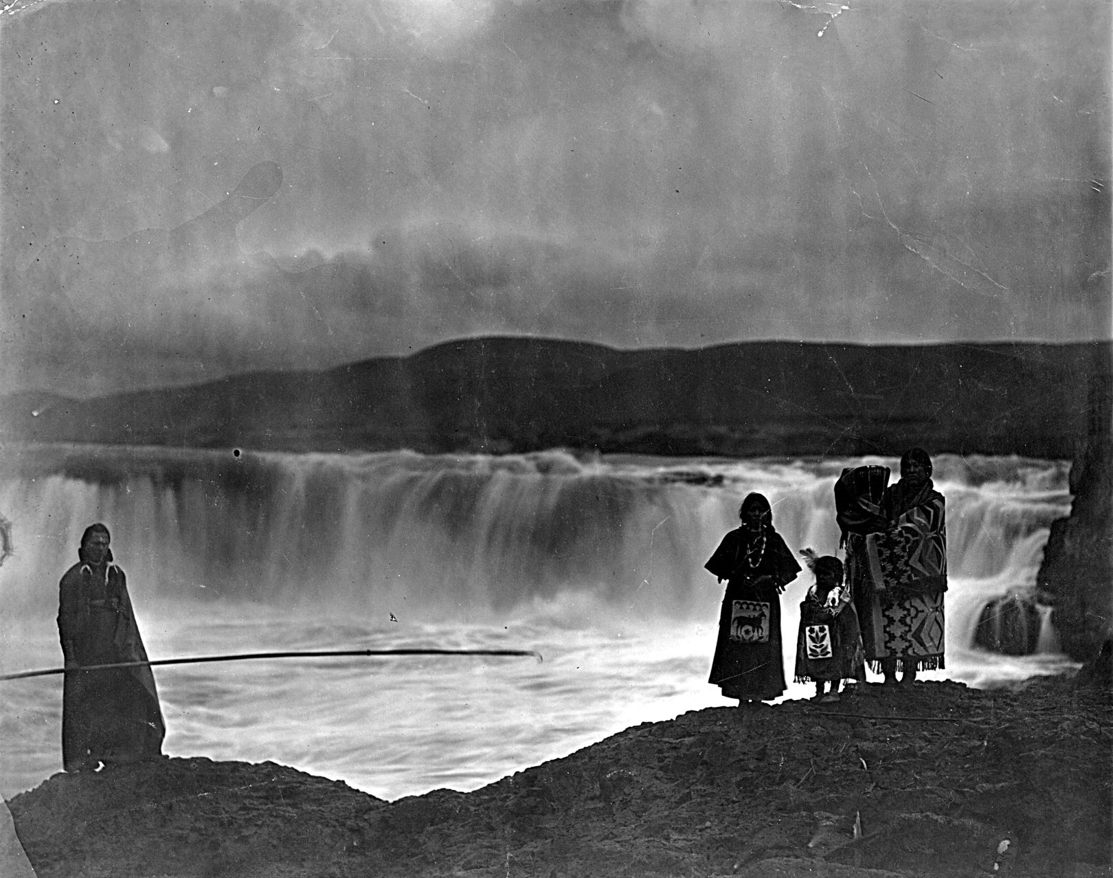 A Native American family is shown standing near Celilo Falls, a longtime fishing and trading spot for Native Americans, on the Columbia River in this undated photo.  The falls were flooded when The Dalles Dam was constructed in 1957.