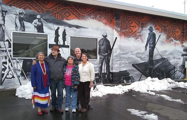 Visitors paid tribute to Celilo Falls and visited The Next Door's new offices March 9 with unveiling of a new mural featuring the historic falls. Pictured above are, left to right, Patricia Whitefoot, a speaker at the event; Toma Villa, the mural artist; Linda Meanus, a speaker at the event; Tim Shampoe, The Next Door's Klahre House Alternative School administrator and Pamela Larsen, developer of the Confluence in the Classroom education program.