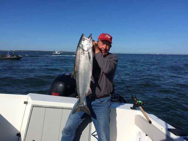 Fisherman holds his Fall Chinook for photo near the mouth of the Columbia River.