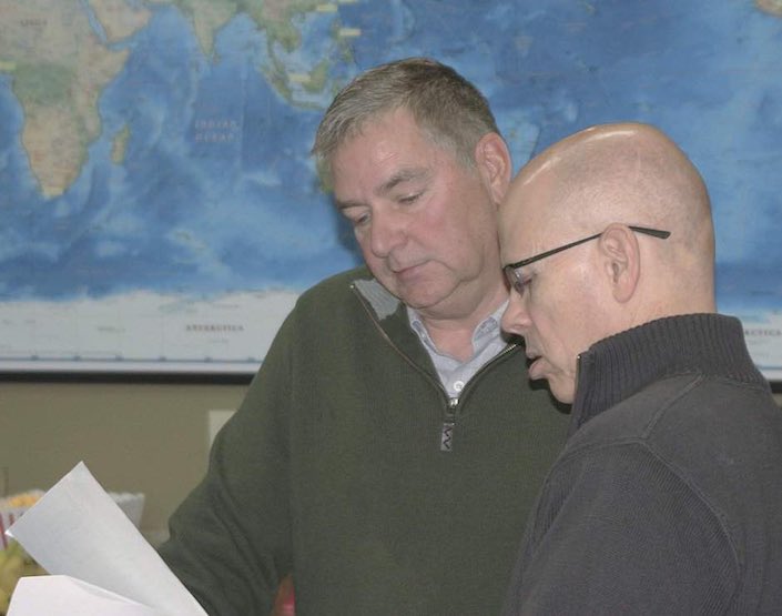 Gary Bailey, new chairman of the Washington Grain Commission, left, goes over paperwork with CEO Glen Squires Jan. 4 during the board meeting in Spokane.