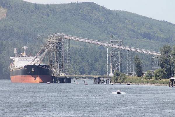 (Don Jenkins photo) A ship takes on grain at the Port of Kalama on the Columbia River in Washington state. A large worldwide supply of wheat and the strong dollar are impacting wheat exports, but low-protein wheat grown in the Northwest is still sought after in Asian markets.