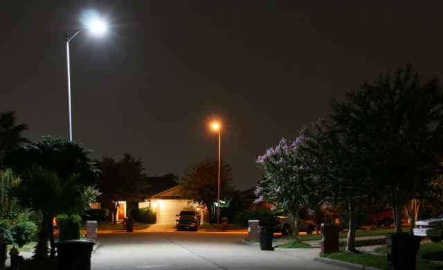 As this streetlight test in Houston shows, LED streetlights (front) emit a whiter light than less-efficient conventional streetlights (back).