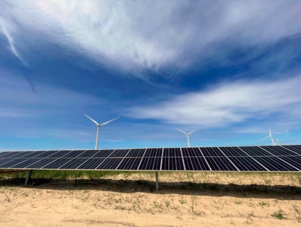 In this photo provided by Portland General Electric, windmills are seen at a renewable energy facility in Lexington, Ore., May 24, 2022, that combines solar power, wind power and massive batteries to store the energy generated there. The Wheatridge Renewable Energy Facilities was commissioned Wednesday, Sept. 28, 2022, and is the first utility-scale plant of its kind in North America. Clean energy experts say the project, which can power 100,000 homes, addresses some key challenges facing the industry as the U.S. transitions away from fossil fuels. (Sarah Hamaker/Portland General Electric via AP)