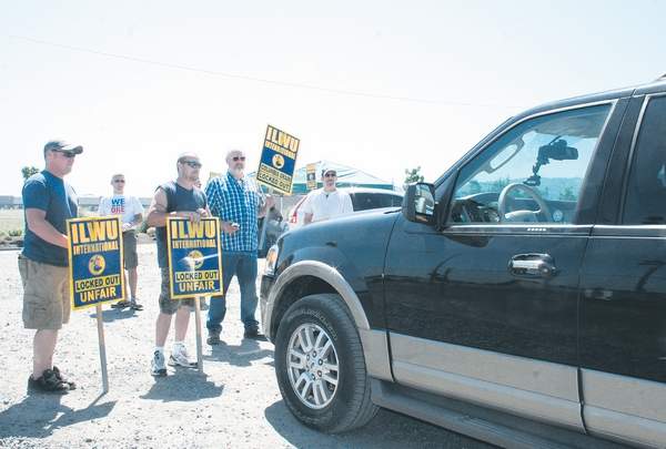 Longshoremen temporarily blocked vehicles driven by security guards, managers and temporary replacement workers from entering and exiting the Columbia Grain export terminal in Portland, Ore., in protest of the company's decision to lock out union members from working. The company said it was responding to escalating work slowdowns.