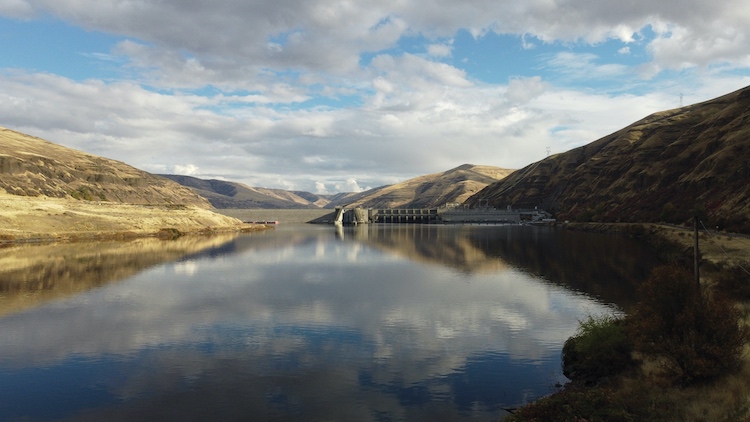 Lee Whiteplume (Nez Perce) stands on a platform on the Clearwater River, a tributary of the Snake, where he uses a hoop net to catch salmon. (photo Hayley Austin/High Country News)