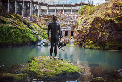 DamNation producer and underwater photographer Matt Stoecker emerges from the icy tail waters below the former Elwha Dam in a scene from DamNation. (Photo: Ben Knight)