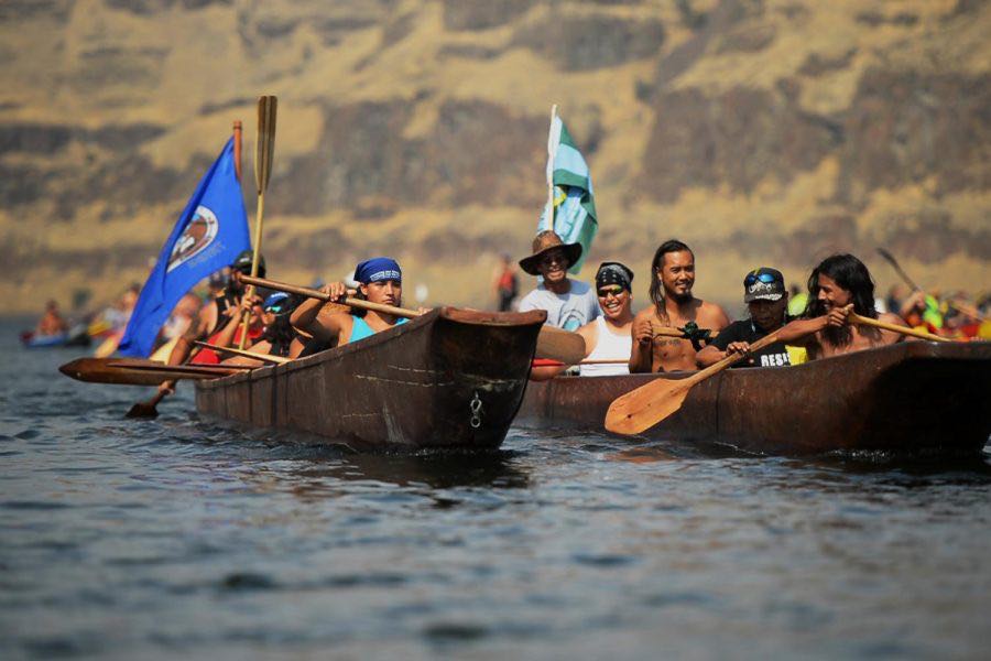 Nez Perce Tribal members paddle down the river Saturday afternoon at the 