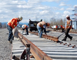 Railworkers install rail.