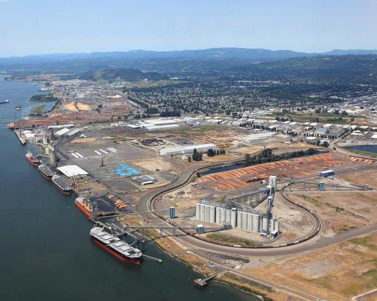 The barge in the foreground of this photo unloads wheat (actually it is loading wheat - bluefish correction) into the Export Grain Terminal, known as the EGT, at its facility at the Port of Longview. Barges <strike>like this</strike> use the Columbia/Snake River system to move nearly 10 percent of all U.S. wheat exports each year. (Port of Longview photo)