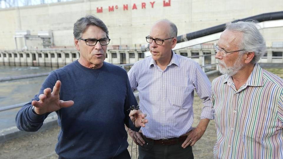 Energy Secretary Rick Perry, left, toured McNary Dam with Rep. Greg Walden R-Ore. and Rep. Dan Newhouse, R-Wash., right, in August 2018. He said he supports using the Snake and Columbia river dams to generate electricity. File Tri-City Herald