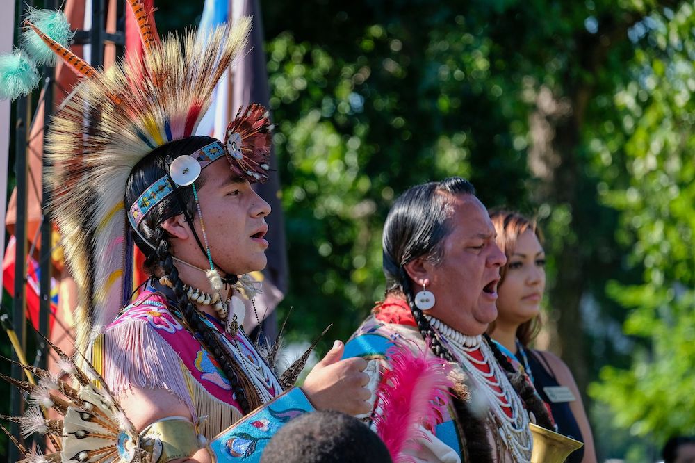 Nakia Williamson (right) and his son, Sewaas, members of the Nez Perce Tribe, sing at a rally outside the U.S. Capitol on July 14, 2022, organized by Northwest tribes in support of breaching the Lower Snake River dams to help restore salmon runs. (Orion Donovan-Smith, The Spokesman-Review)