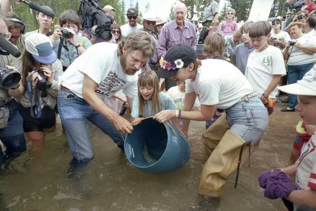 Charles Ray of McCall, left, and actress Jamie Lee Curtis join Allyson Coonts, center, in releasing sockeye into Redfish Lake on Aug. 12, 1993. Gov. Cecil Andrus is behind them. RedFish BlueFish videographer Arianne Russell left of Charles Ray.