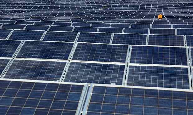 A maintenance worker examines solar panels at Norsol solar energy company in Villaldemiro, northern Spain. (Photograph: Cesar Manso/AFP/Getty Images)