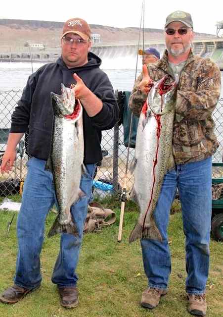Andrew Barboe, left, Hermiston, and John Addleman, Oregon City, hold up spring Chinook salmon they hauled in Thursday afternoon along the Columbia River below McNary Dam.