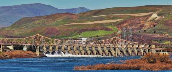 The Dalles Dam is shown behind The Dalles Bridge on the Columbia River in The Dalles, Oregon.