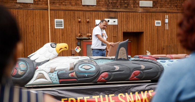 Lummi tribal member Freddie Lane describes the totem pole’s carvings and its cross-country journey, called the Red Road to DC. The totem pole journey will continue to raise awareness in calling for protecting sacred lands and waters of Indigenous people. (Amanda Snyder / The Seattle Times)
