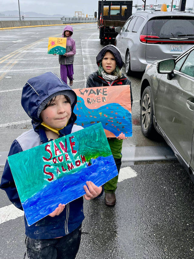 Vashon Green School students worked the ferry line to raise awareness and inspire action to protect endangered salmon and orcas. (Dana Schuerholz Photo)