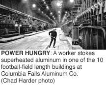 Power Hungry: A worker stokes superheated aluminum in one of the 10 football-field length buildings at Columbia Falls Aluminum Co. (Chad Harder photo)