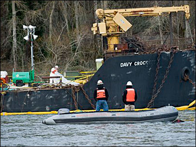 A crew from Ballard Diving stands by as one of their divers checks the condition of the Davy Crockett on the Columbia River near Camas, Wash., 1/31/11.