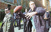 Democratic Presidential Canditate Bill Bradley shows off his throwing arm Thursday while touring the University of Washington campus in Seattle