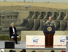 (AP Photo) President Bush speaks at the Ice Harbor Lock and Dam near Burbank, Washington on Friday as Interior Secretary Gale Norton looks on.