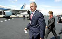 (John Lok) President Bush heads to a podium yesterday on the runway at Boeing Field after meeting for about 30 minutes with six local business leaders.