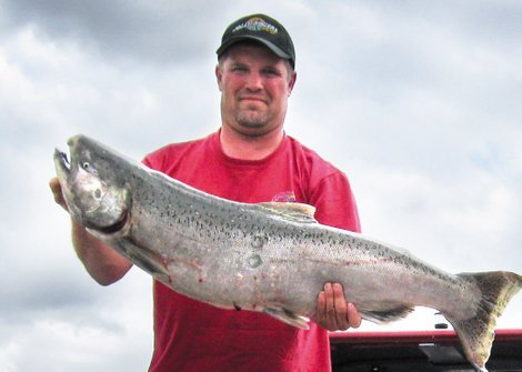 A fisherman displays his salmon catch.