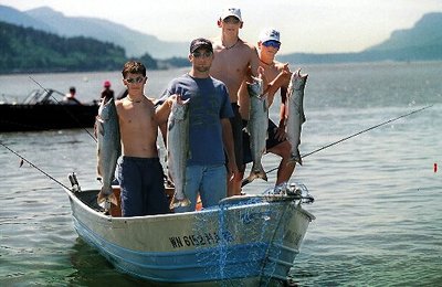 (Associated Press) Four young fishermen hold their chinook catch for display.