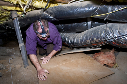 (Doug Beghtel) Adam Zielinski with Sustainable Solution crawls under a Lake Oswego home in 2009 to look for problems in the old duct works. A federal agency says the Northwest can use efficiency improvements in homes, business and the grid to meet most of the region's new energy demand.