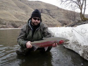 Mike Beard, a fly-fishing guide at Orvis Northwest Outfitters in Coeur d'Alene, shows off a nice Idaho steelhead. This time of year, fishermen hunt steelhead in the cold waters of the Clearwater or snake rivers.