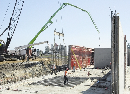 During construction in mid-August 2010, concrete workers build the walls of a massive dairy digester just west of Lynden, Wash. The anaerobic digester is now in operation, one of two operated by Farm Power Northwest.
