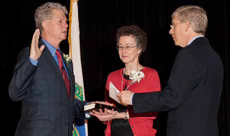 Bill Drummond (left), accompanied by his wife, Elizabeth, takes the oath of office, which was administered by Department of Energy Deputy Secretary Daniel Poneman.