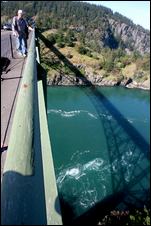 (Scott Eklund) Public utilities and the University of Washington are eyeing tidal power as a source of green energy, a technology that's still in its infancy and raises a lot of questions. Howard McNicol of Seattle checks out the view and the currents on the bridge at Deception Pass.