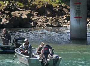 Fisherman try their luck near below a bridge demarking the WDFW fishing boundary.