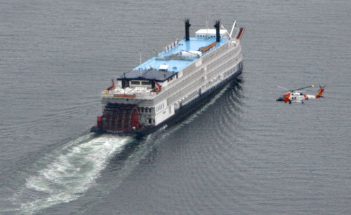 (Brian Wallace) The cruise ship Empress of the North is circled by a Coast Guard helicopter May 14, 2007, as it steams back to Juneau under its own power. The Coast Guard successfully evacuated the passengers from the ship after it ran aground on Hanus Reef in Icy Strait.