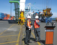 Gov. Ted Kulongoski, left, and Port of Portland Executive Director Bill Wyatt talk prior to a ceremony July 19 in which the state handed the port a $7.5 million check for the purchase of a fourth Post-Panamax crane