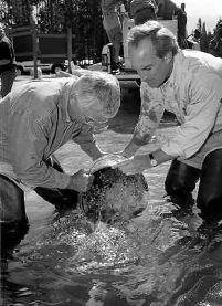 Tom Shanahan photo.  Gov. Dirk Kempthorne and Idaho House Speaker Bruce Newcomb helped release the 18 hatchery-raised fish that returned to Redfish Lake last year. More than 100 sockeye have made it back so far this summer.