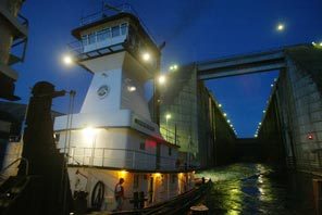 The tug Lewiston emerges from the locks at Lower Granite Dam just after dusk having been lowered about 100-feet.