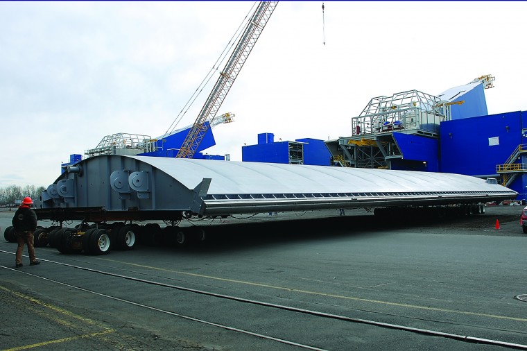 The first leaf of the new The Dalles navigation lock downstream gate rolls out of Thompson Metal Fab's shop in Vancouver, Wash., on Friday.
