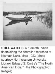 (Edward S. Curtis) A Klamath Indian floats along the shoreline marshes of Klamath Lake, circa 1923.