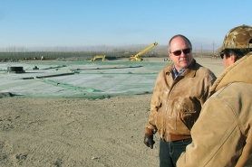(Dean Brickey) Marty Myers, left, general manager at Threemile Canyon Farms, talks with employee Tom Chavez about the operation of the new methane digester, which is expected to reduce the farm's natural gas use.