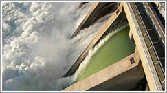 The smooth green water of a fish weir (closest spillway) lets young salmon slide over a dam in the surface water they prefer. (U.S. Army Corps of Engineers photo)