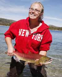 Tomi Quigley, who worked as a biological aide at the Sawtooth Fish Hatchery last year, releases one of nearly 250 sockeye salmon into Redfish Lake last September. Because of an expected increase in sockeye returns this summer over last year--which itself saw the best returns in decades--fisheries officials have decided to allow some of the 2010 run to migrate to Redfish naturally. (Photo by Mountain Express)