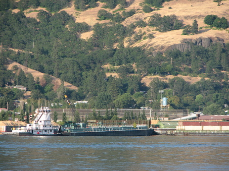 The barge New Dawn, being pushed by the tug The Chief, heads up the Columbia River tonight after being freed from a sandbar at the mouth of the Hood River. It had been stuck since early Thursday but floated free after its fuel payload was unloaded onto a second barge. (Matthew Preusch/Oregonian photo)