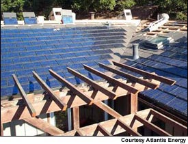 Shown under construction, this Palo Alto, California home has Atlantis Energy roofing tiles and AstroPower PV modules. The five-kilowatt system has a battery backup and is also linked to the local utility.